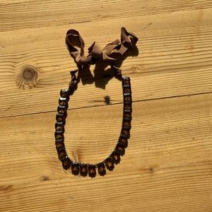 Brown statement necklace with ribbon closure